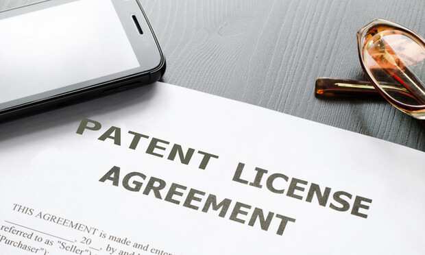 Patient License Agreement on Desk with Phone Glasses and Pen